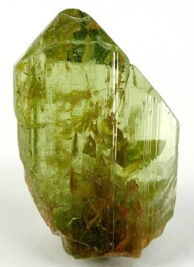 Green Peridot crystals and polished gemstone showing yellow-green colour and natural inclusions