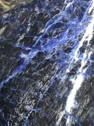 Royal-blue Sodalite stone with white veining and dark mineral inclusions