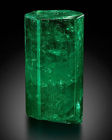 Natural green Emerald crystal showing rich colour and characteristic internal inclusions