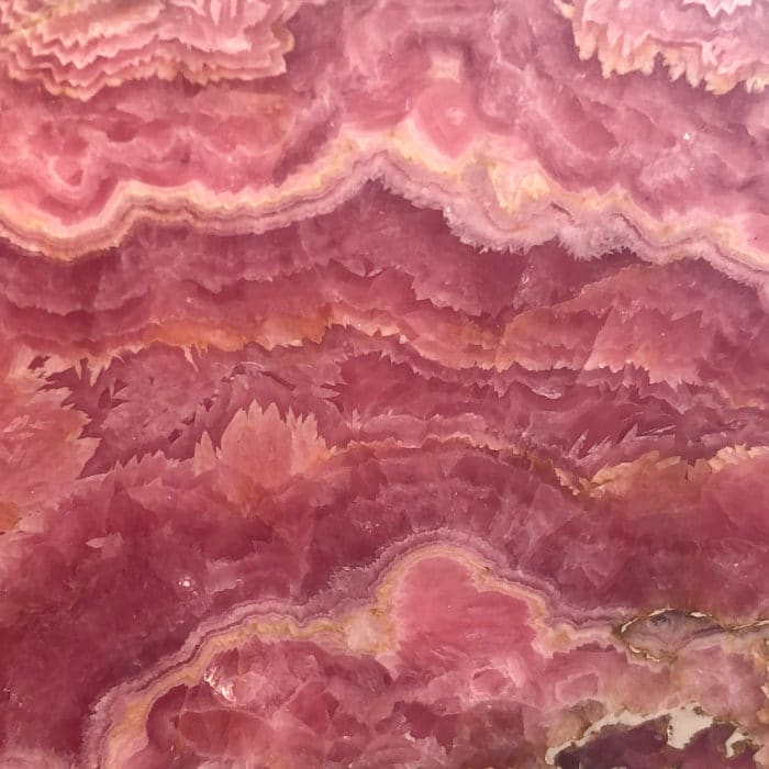 Pink Rhodochrosite showing white banding and rich red mineral layers